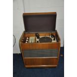 A FERGUSON 322RG VINTAGE RADIOGRAM in walnut case with a Garrard RC75M turntable (PAT pass and