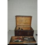 A STAINED PINE TOOLBOX with double opening and two trays containing woodworking tools including five