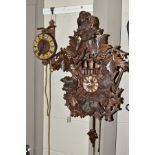 A MID 20TH CENTURY CARVED WOODEN CUCKOO CLOCK, the fruiting vine pediment with two owls to the