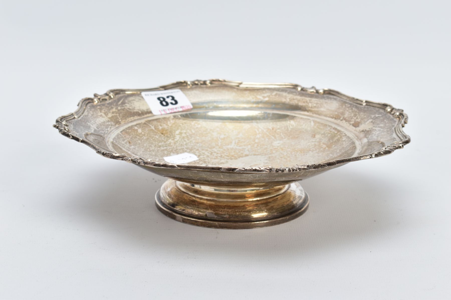 A SILVER MAPPIN AND WEBB DISH, of a circular form with a shell decorated wavy edge, on a raised