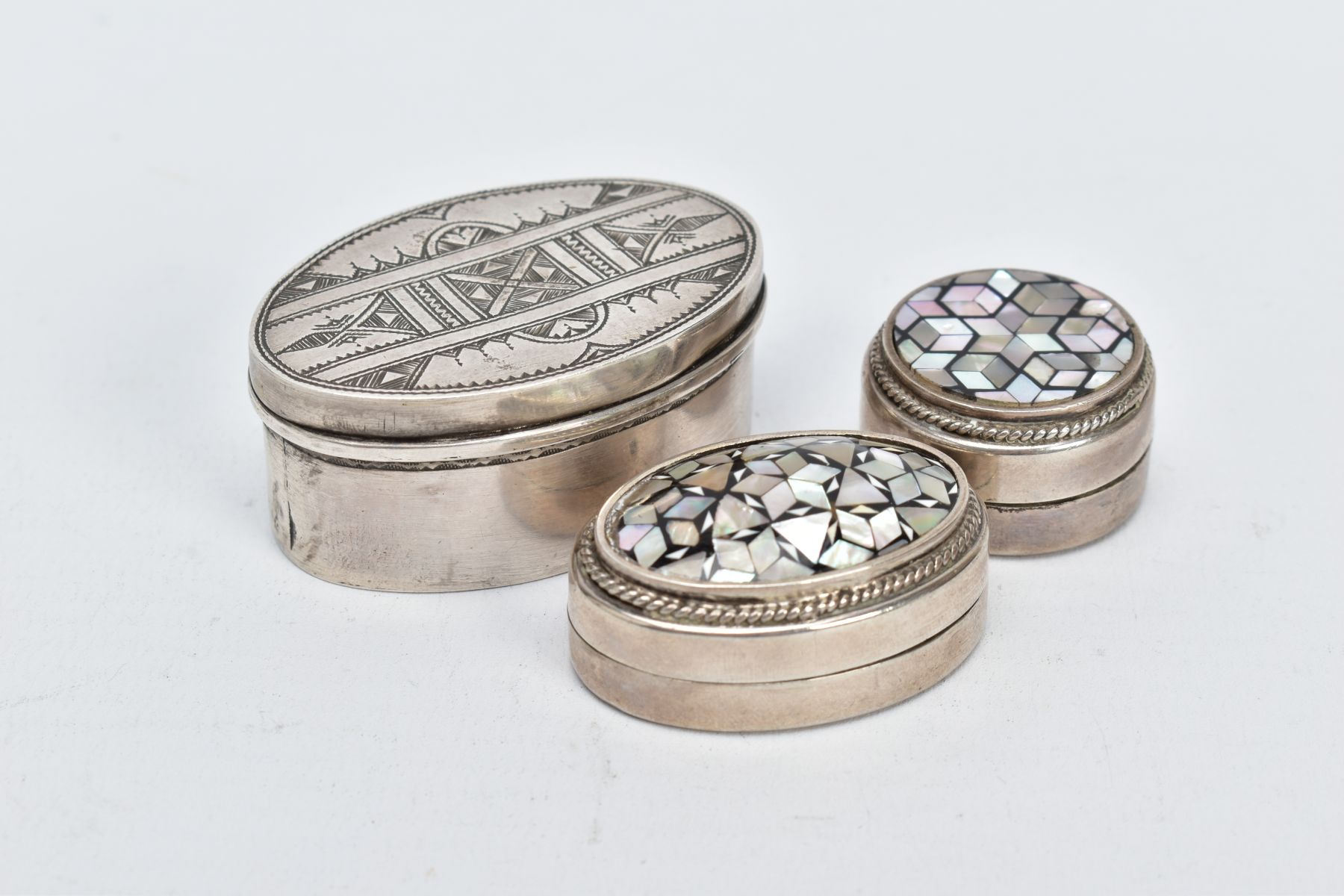 TWO EGYPTIAN SILVER PILL BOXES AND A WHITE METAL TRINKET BOX, two pill boxes of a circular and - Image 2 of 3