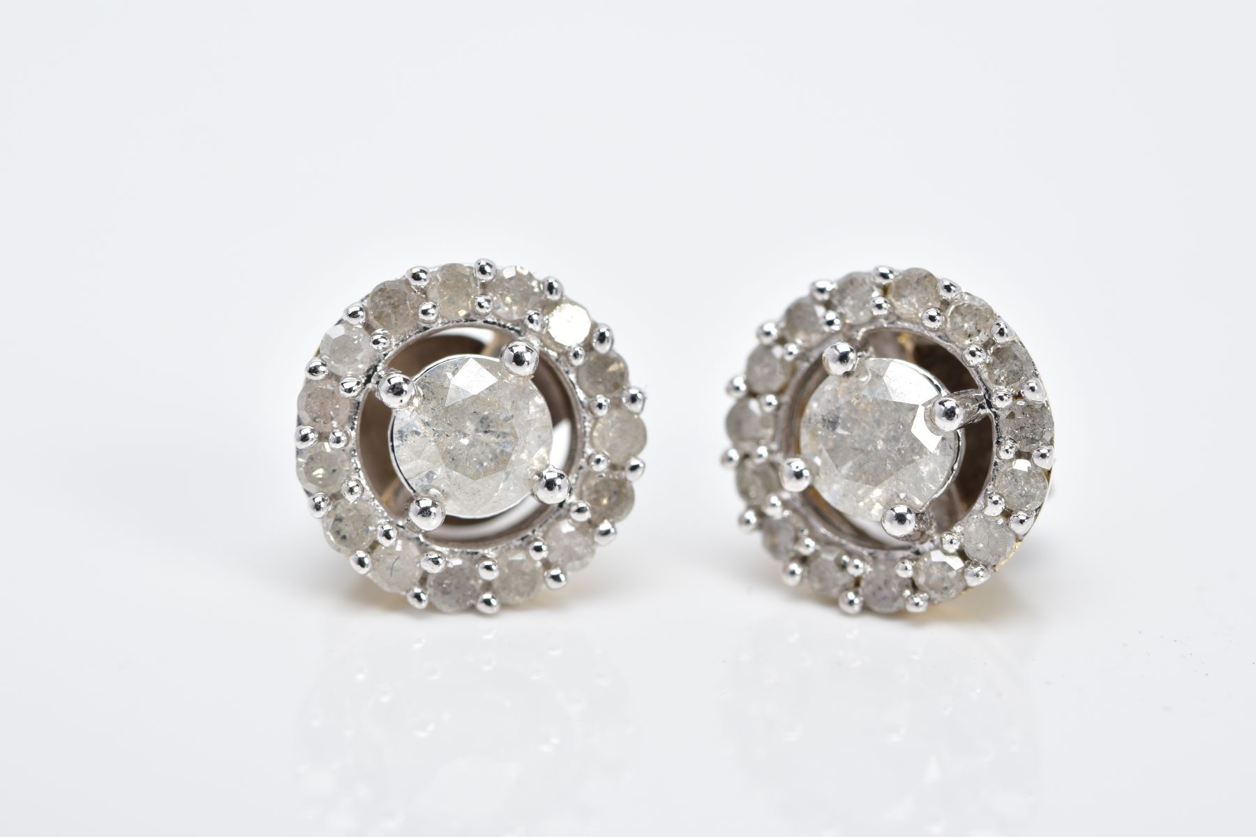 A PAIR OF HALO DIAMOND EARRINGS, each of an openwork circular form, set with a central claw set