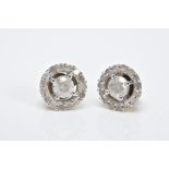 A PAIR OF HALO DIAMOND EARRINGS, each of an openwork circular form, set with a central claw set