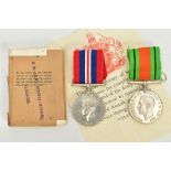A BOXED PAIR OF WWII WAR AND DEFENCE MEDALS with ribbons un-named as issued, with issue slip to a Mr