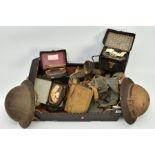 A LARGE BOX OF MISCELLANEOUS WWII ERA MILITARIA, namely two British steel helmets with liners etc,