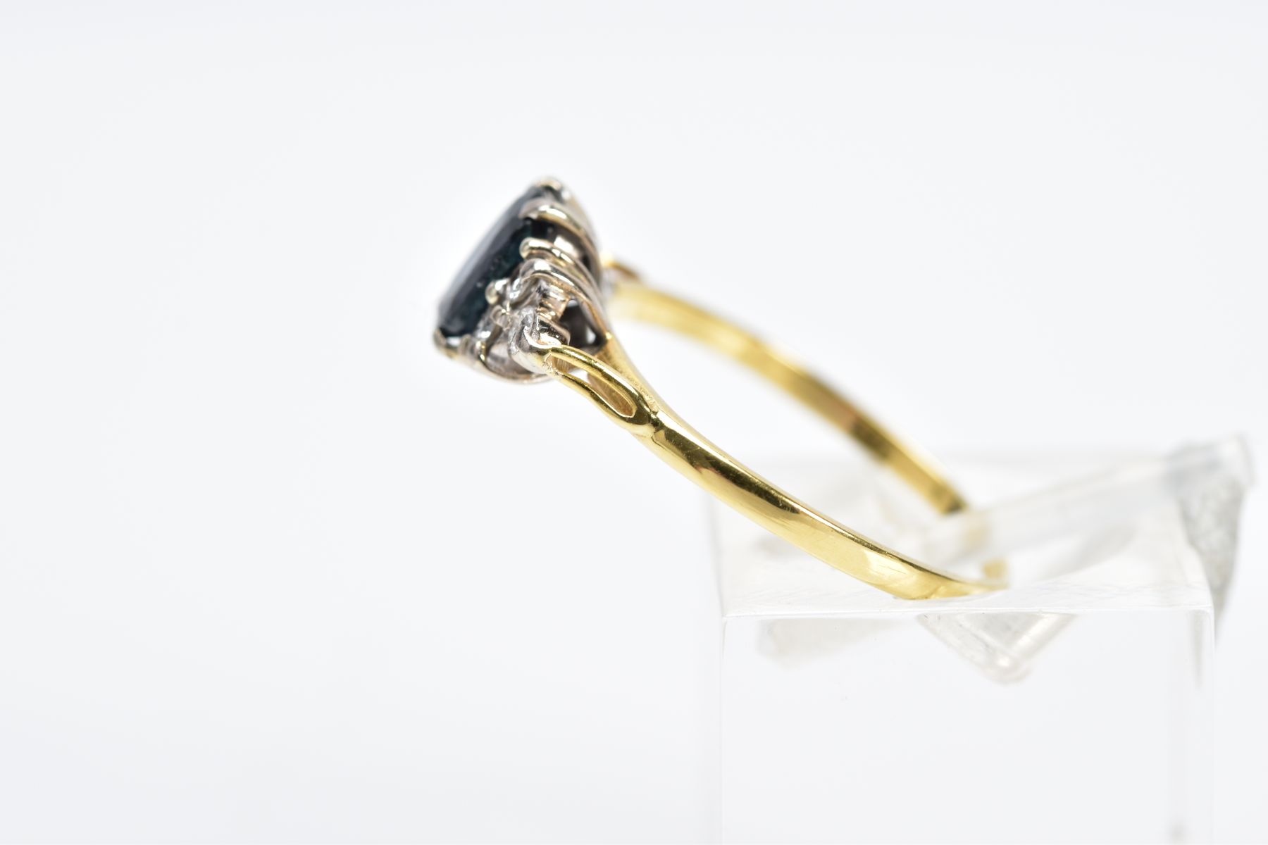 A SAPPHIRE AND DIAMOND RING, the yellow metal ring designed with an oval cut sapphire, flanked - Image 2 of 3