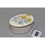 A SMALL MOORCROFT POTTERY OVAL COVERED TRINKET DISH, 'Campanula' pattern on cream ground,