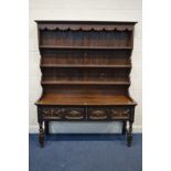 AN OAK DRESSER, incorporating some timbers from the Georgian era, the top with a wavy apron, three