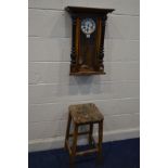 A LATE VICTORIAN WALNUT VIENNA WALL CLOCK (winding key, losses) and a beech stool (sd) (2)