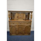 AN EARLY TO MID 20TH CENTURY OAK LINENFOLD COURT CUPBOARD, with three drawers and three cupboard