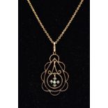 A 9CT GOLD EDWARDIAN PENDANT NECKLACE, the pendant of an openwork scrolls and scallop edge design,
