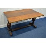 AN EARLY 20TH CENTURY OAK EXTENDING DINING TABLE, one additional leaf, on twin bulbous legs, width