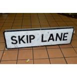 AN ALUMINIUM STREET NAME SIGN, Skip Lane, probably from Walsall, wall mounted sign with raised black