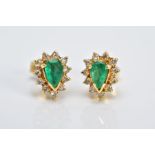 A PAIR OF YELLOW METAL, EMERALD AND DIAMOND CLUSTER EARRINGS, each designed with a central claw set,