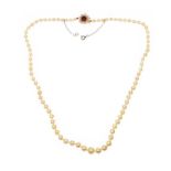 STRAND OF CULTURED PEARLS WITH 9CT GOLD GARNET AND PEARL CLASP