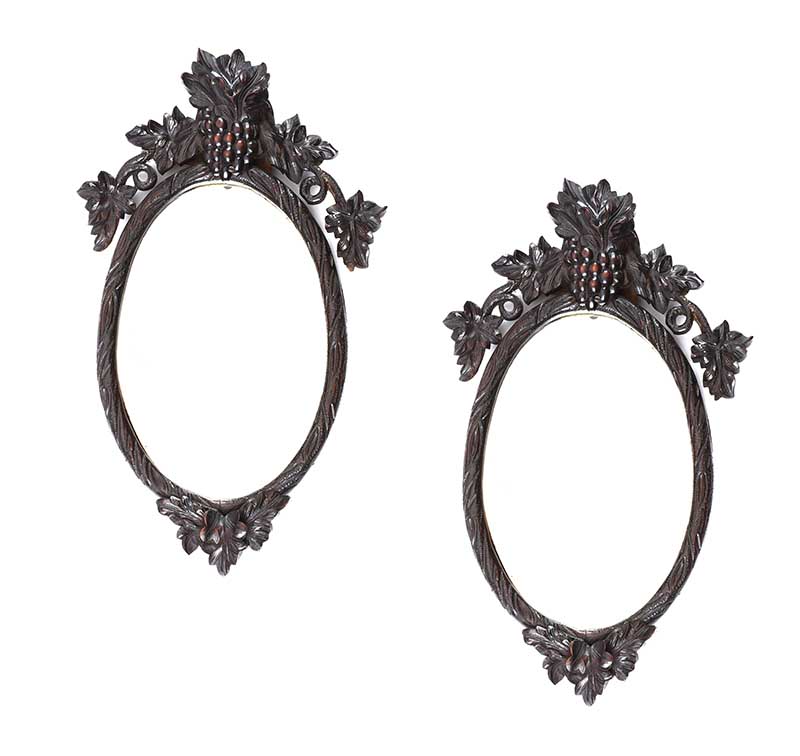 PAIR OF VICTORIAN BLACK FOREST OVAL MIRRORS