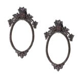 PAIR OF VICTORIAN BLACK FOREST OVAL MIRRORS