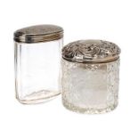 TWO ORNATE CUT GLASS SILVER TOPPED JARS