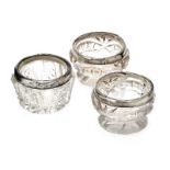 THREE STERLING SILVER TOPPED CUT GLASS SALTS