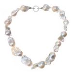 STRAND OF BAROQUE FRESHWATER PEARLS WITH STERLING SILVER CLASP SET WITH CUBIC ZIRCONIA