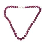 GRADUATED STRAND OF RUBY BEADS WITH A STERLING SILVER CLASP