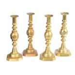 SET OF FOUR BRASS CANDLESTICKS