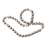 STRAND OF SILVER BEADS
