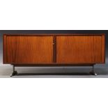 A rosewood sideboard, c.1960, probably Danish, the rectangular top above tambour front enclosing