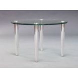 A glass and chromed side table, of recent manufacture, the glass top raised on tapering chromed