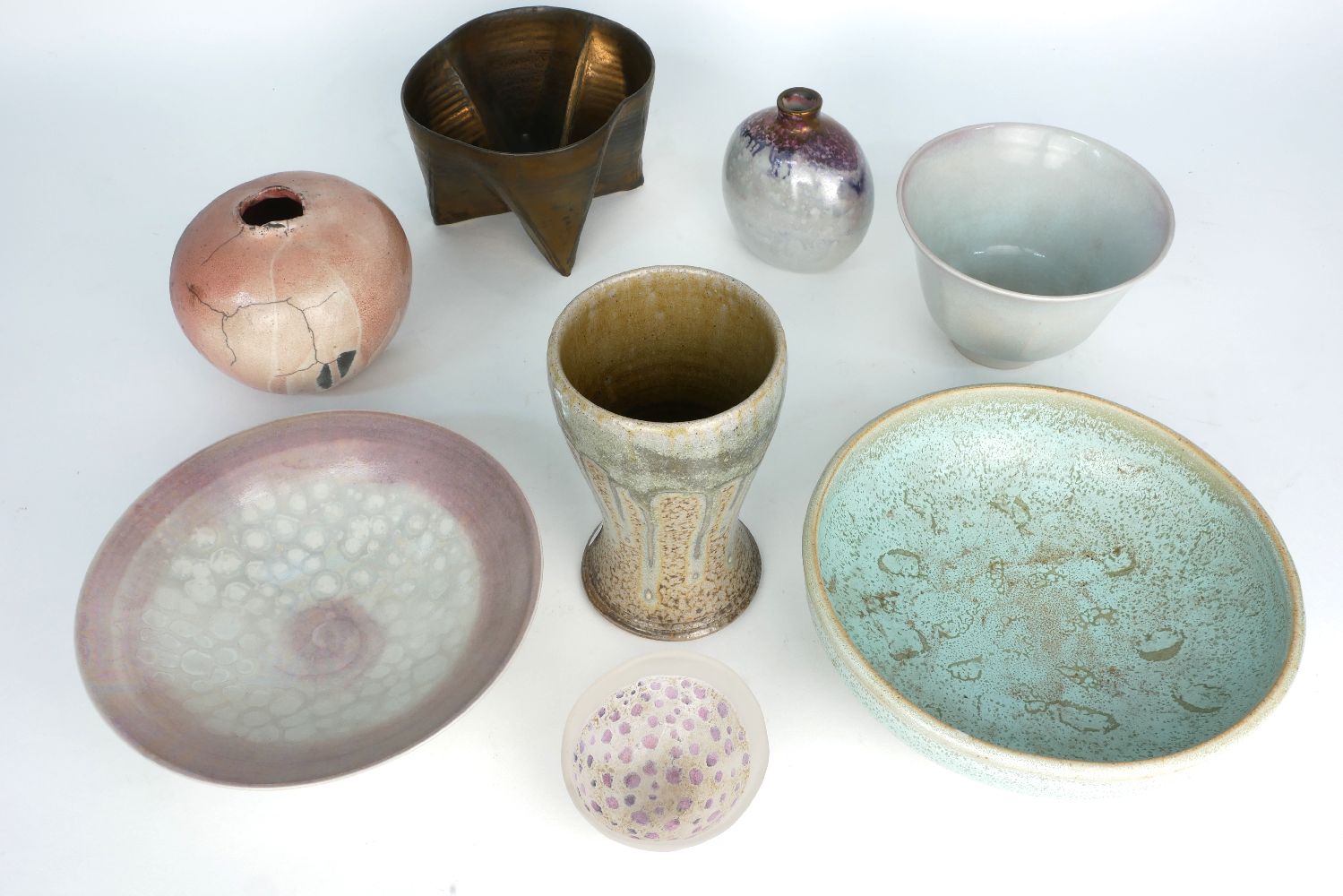 George Wilson, British, 1924-2004, a pink lustre and celadon glazed facetted bowl, a similar low