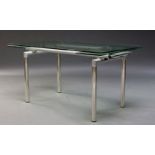 A contemporary extending glass dining table, the rectangular glass top with fold out extensions to