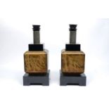 A pair of black lacquered and polished lamp bases, 20th century, the square bodies stencilled in