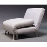 A modern metamorphic lounge chair /daybed, of recent manufacture, upholstered in grey fabric, with