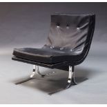 A black leather lounge chair, c.1970, with curved seat raised on chrome supportsPlease refer to