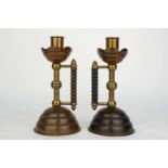 A pair of copper and treen candle sticks, in the manner of Christopher Dresser, mid/late 19th