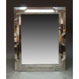 A contemporary wall mirror, of recent manufacture, of rectangular form with raised geometric and