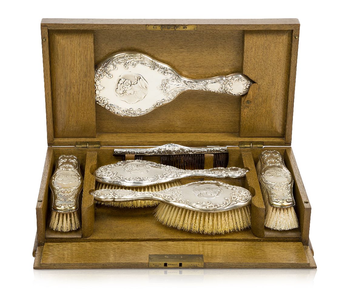 An Edwardian Silver dressing table set in fitted oak box Silver with mark of Henry Matthews,