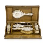 An Edwardian Silver dressing table set in fitted oak box Silver with mark of Henry Matthews,