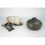Ian Gregory, British, b.1942, a raku pottery reclining dog, monogram to underside, 21cm wide,