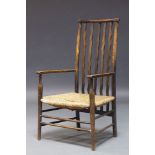 Liberty and Co. a beech and rush seated armchair, early 20th Century, of 3/4 size, the high back