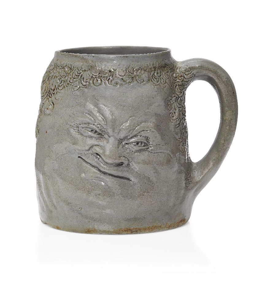 R.W. Martin (1843-1923), a Martin Brothers stoneware Double ‘Face’ mug c.1890, Signed R.W Martin &