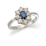 A sapphire and diamond cluster ring, the claw-set oval sapphire within a brilliant-cut diamond