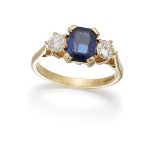 A sapphire and diamond three stone ring, the cut-cornered rectangular sapphire between brilliant-cut