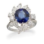 A sapphire and diamond cluster ring, the central oval sapphire in claw mount with marquise and