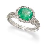 An emerald and diamond cluster ring, the cushion shaped emerald with brilliant-cut diamond twin