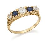 A diamond and sapphire five stone ring, of half-hoop design comprising three graduated brilliant-cut