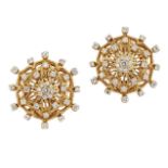 A pair of diamond-set earclips, of pierced stylised flowerhead design with brilliant-cut diamond