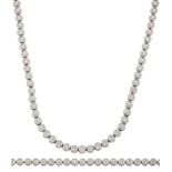 A diamond necklace and bracelet, each composed of a line of collet-set brilliant-cut diamonds,