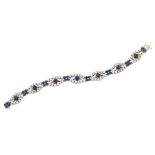 A diamond and sapphire bracelet, composed of a series of circular-cut sapphire and diamond