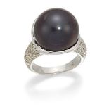 A black cultured pearl and diamond ring, the cultured pearl, diameter approximately 15.6mm, in